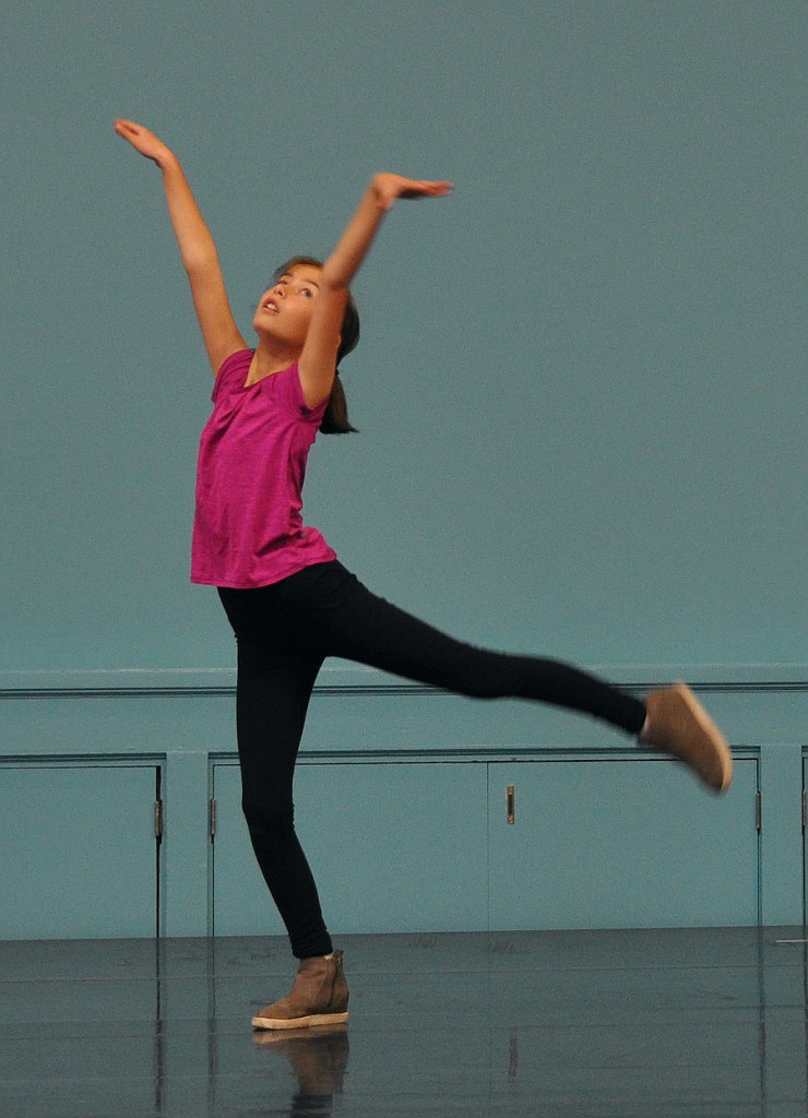 An Intermediate level student performs a stylized arabesque inspired by the crescent moon.